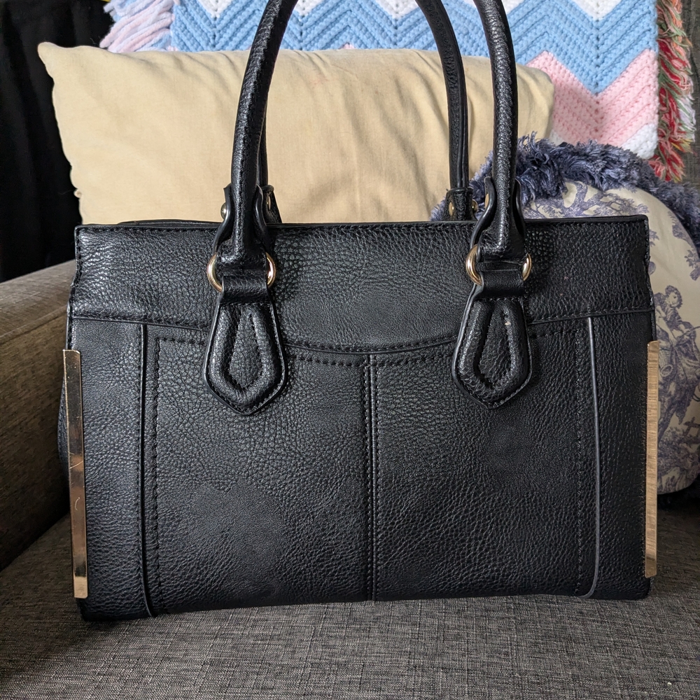 Miztique Black Ladies Handbag With Gold Accents And A Shoulder Strap.